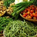 Colorful assortment of fresh vegetables in a local market setting.